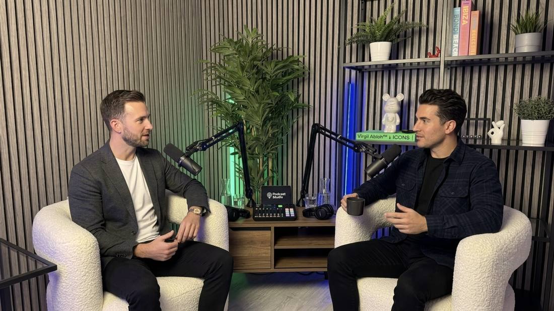 Two men recording a podcast at the console desk